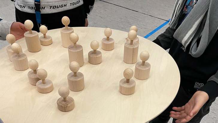teamspiel, gruppenübung, holzfiguren, koordination, balance, gemeinschaft